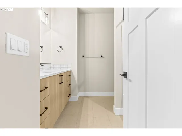 a bathroom with a double vanity sink a mirror and a shower