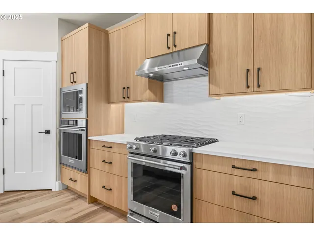 a kitchen with cabinets and appliances