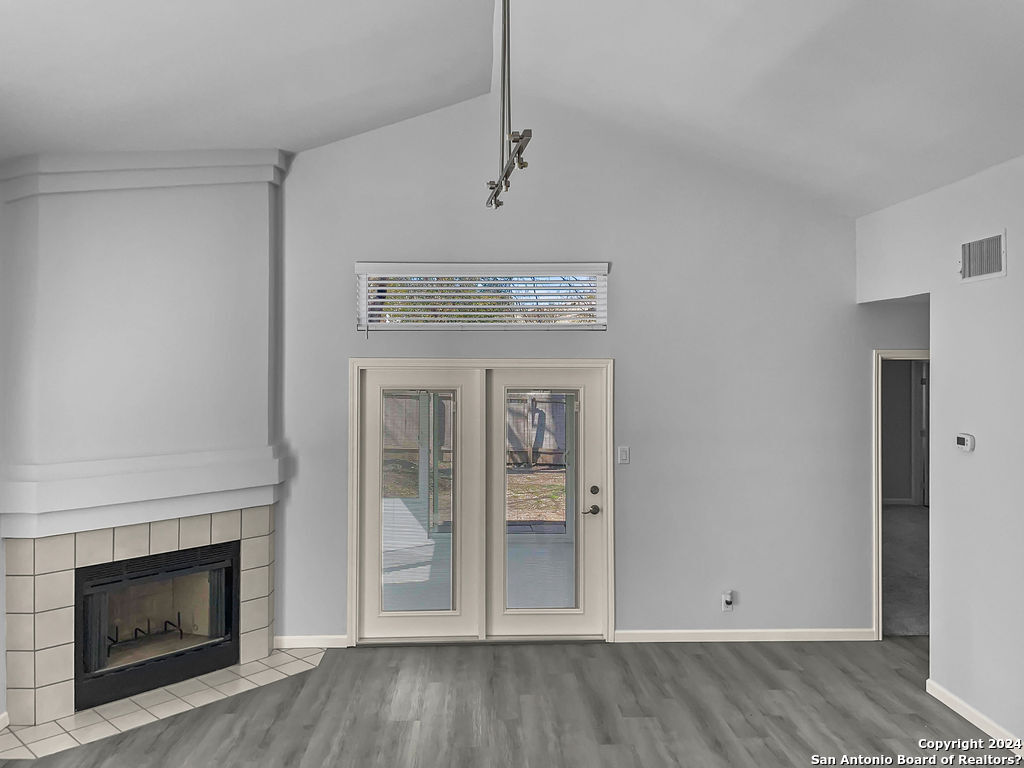 13211 Huntsman Road San Antonio, TX 78249 - Photo 14 of 33 a view of a livingroom with wooden floor and a fireplace