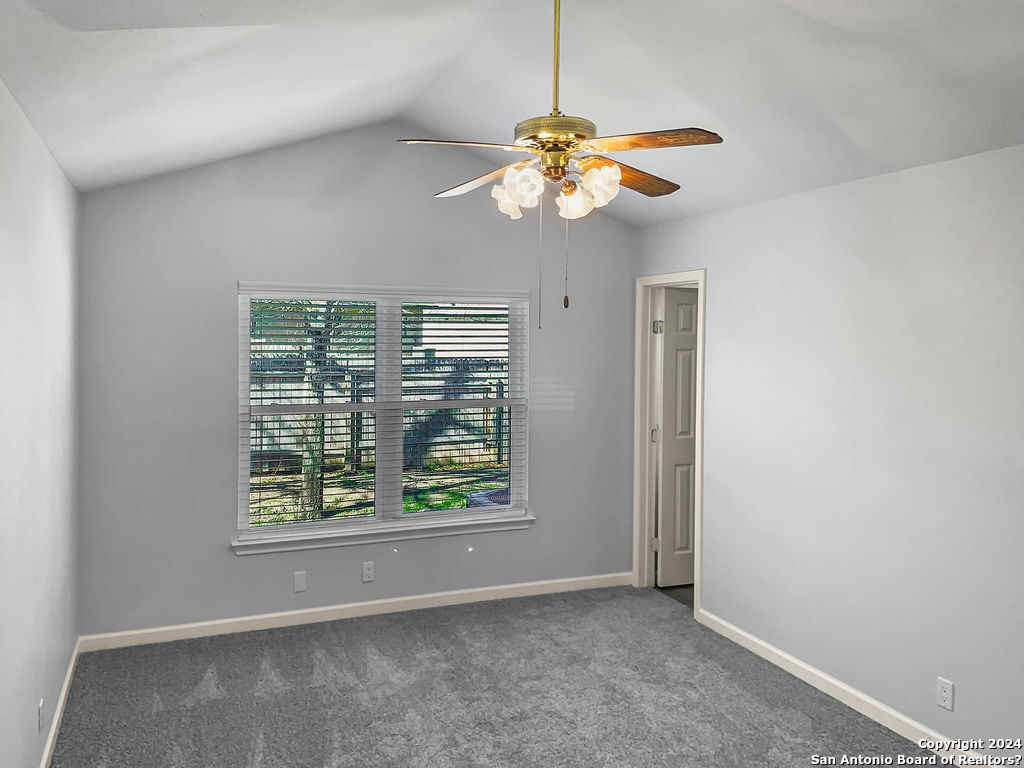 13211 Huntsman Road San Antonio, TX 78249 - Photo 15 of 33 an empty room with windows and chandelier fan
