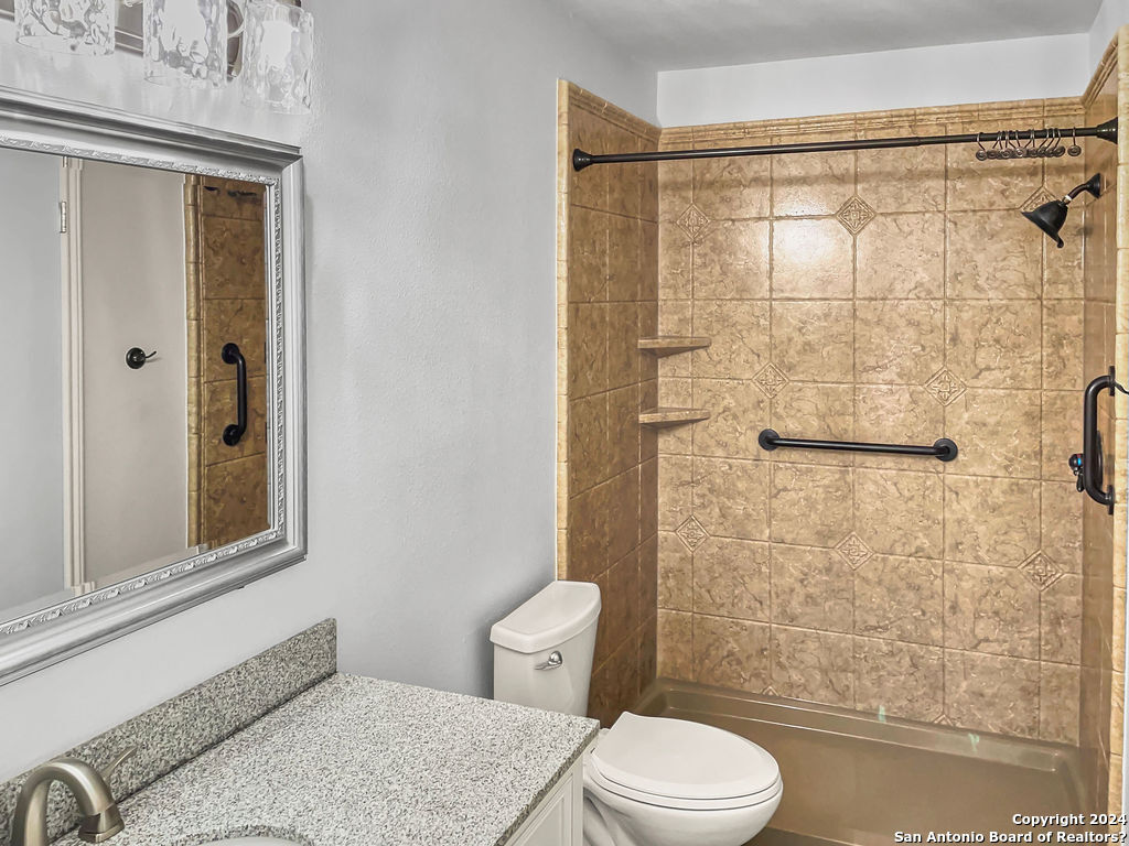 13211 Huntsman Road San Antonio, TX 78249 - Photo 19 of 33 a bathroom with a granite countertop bathtub shower sink vanity and toilet