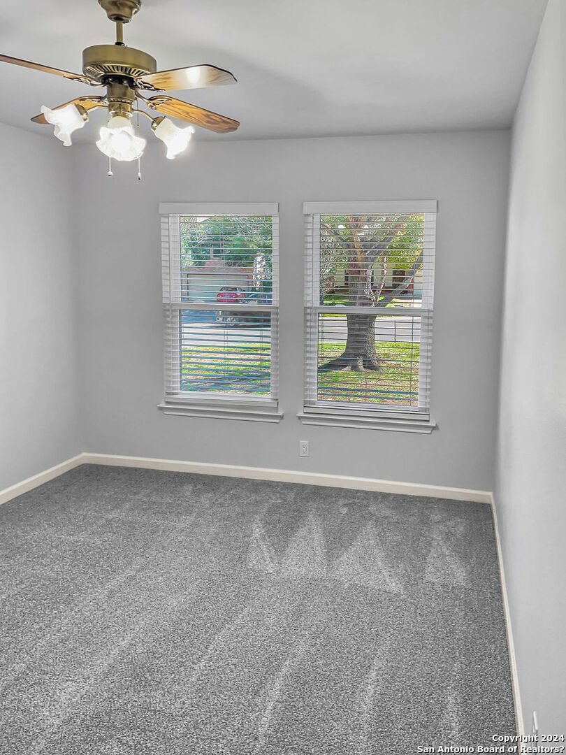 13211 Huntsman Road San Antonio, TX 78249 - Photo 20 of 33 an empty room with windows and fan