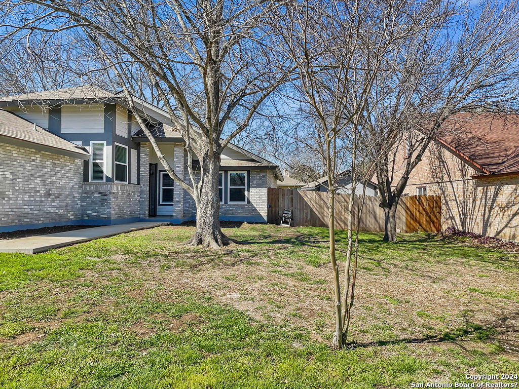 13211 Huntsman Road San Antonio, TX 78249 - Photo 2 of 33 a view of a house with a yard
