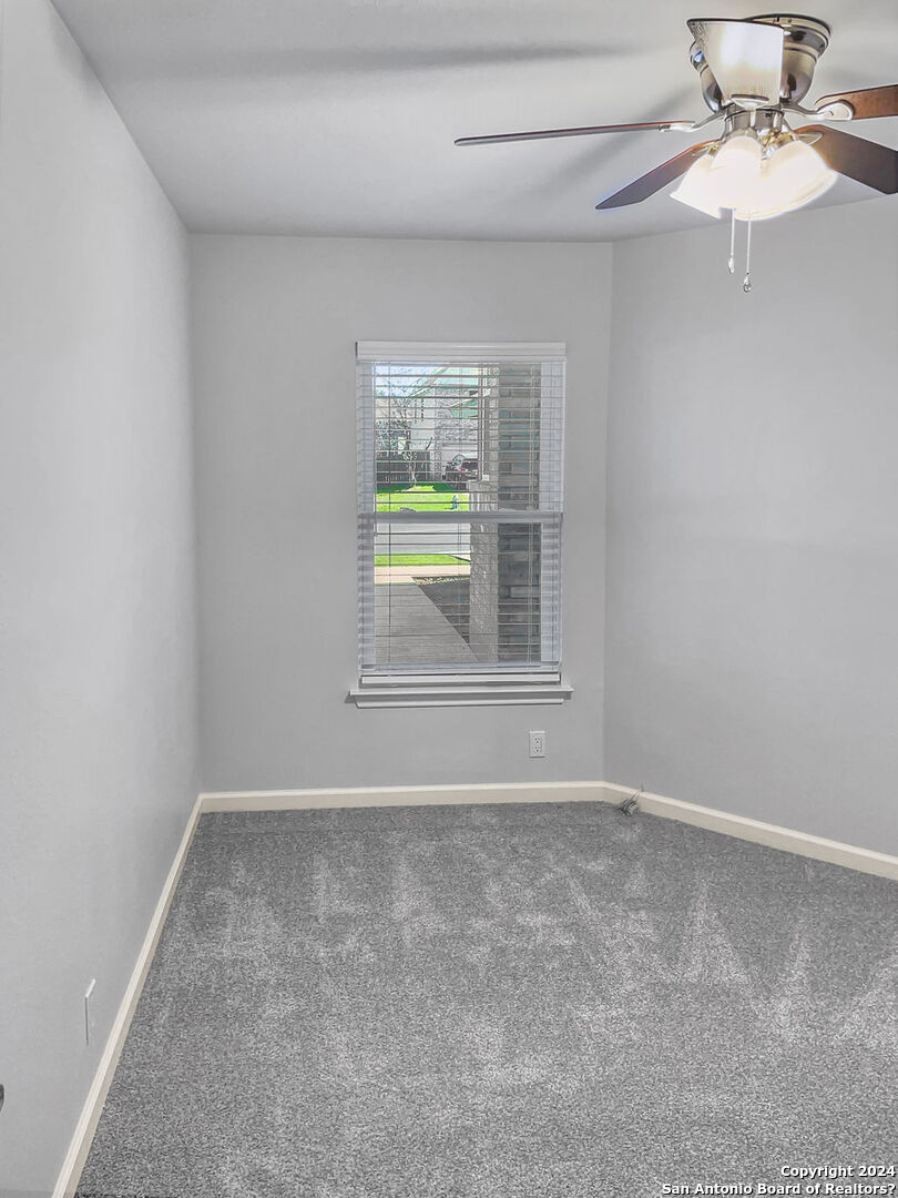 13211 Huntsman Road San Antonio, TX 78249 - Photo 24 of 33 an empty room with a window and a ceiling fan