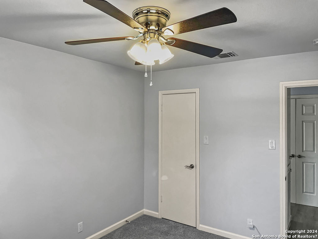 13211 Huntsman Road San Antonio, TX 78249 - Photo 26 of 33 a view of a hallway with a chandelier fan and a table