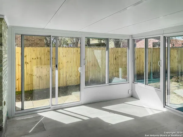 a bathroom with a glass shower and a large window