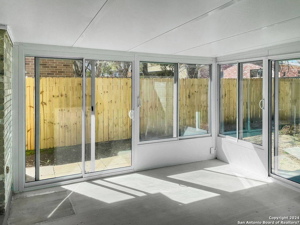 13211 Huntsman Road San Antonio, TX 78249 - Photo 27 of 33 a bathroom with a glass shower and a large window