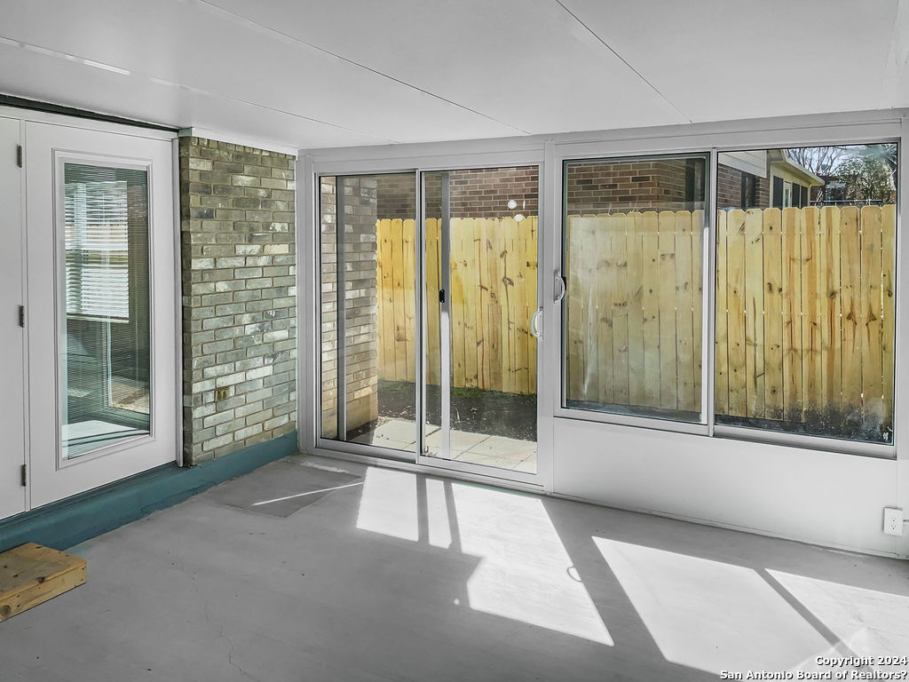 13211 Huntsman Road San Antonio, TX 78249 - Photo 29 of 33 a view of a spacious bedroom with a large window and balcony