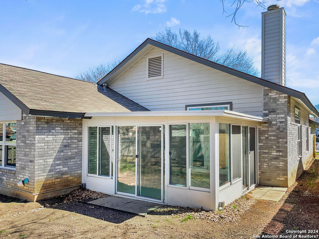 13211 Huntsman Road San Antonio, TX 78249 - Photo 30 of 33 a view of a house with a backyard