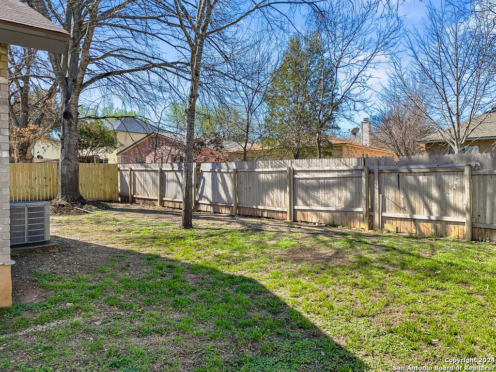 13211 Huntsman Road San Antonio, TX 78249 - Photo 33 of 33 a view of yard with swimming pool and trees