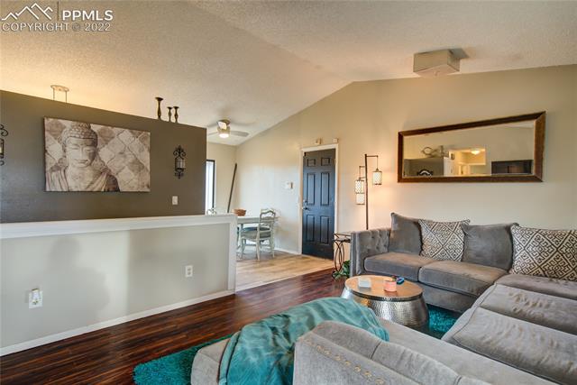 2115 Bainbridge Road Colorado Springs, CO 80916 - Photo 8 of 22 Open living room, looking into the dining area