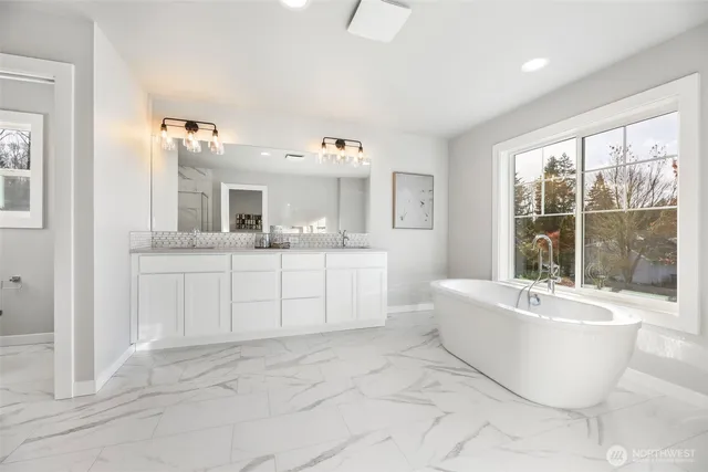 a large white kitchen with a large window