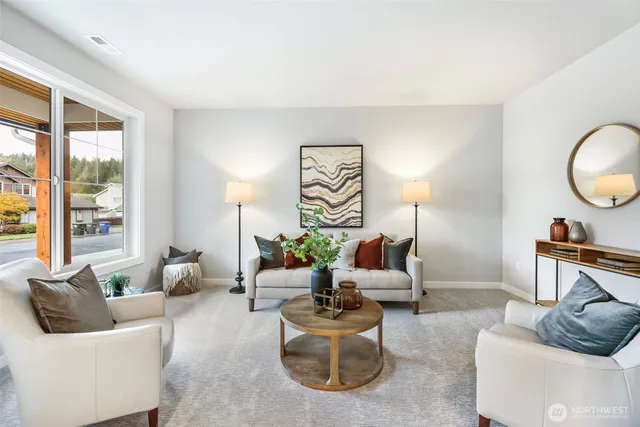 a living room with furniture and a potted plant