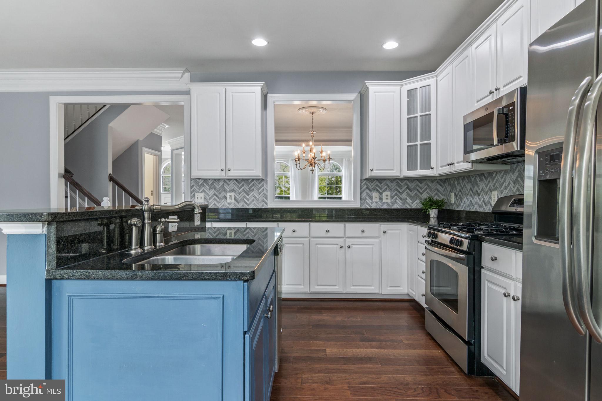 5893 Riverside Drive Woodbridge, VA 22193 - Photo 11 of 36 a kitchen with stainless steel appliances granite countertop a sink stove and refrigerator