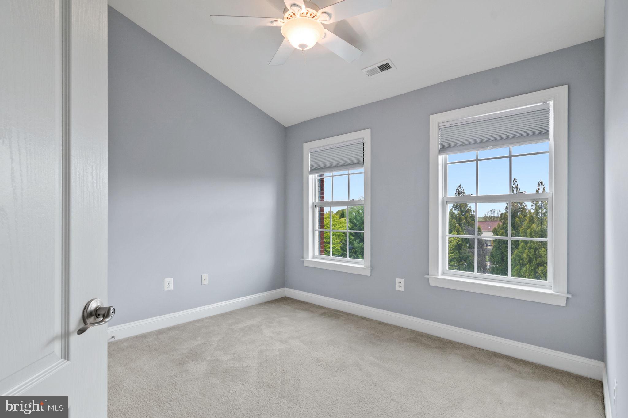 5893 Riverside Drive Woodbridge, VA 22193 - Photo 24 of 36 an empty room with windows and chandelier fan