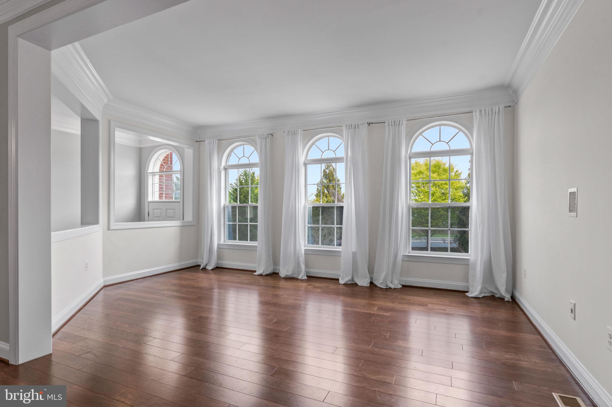 5893 Riverside Drive Woodbridge, VA 22193 - Photo 4 of 36 a view of an empty room with wooden floor and a window