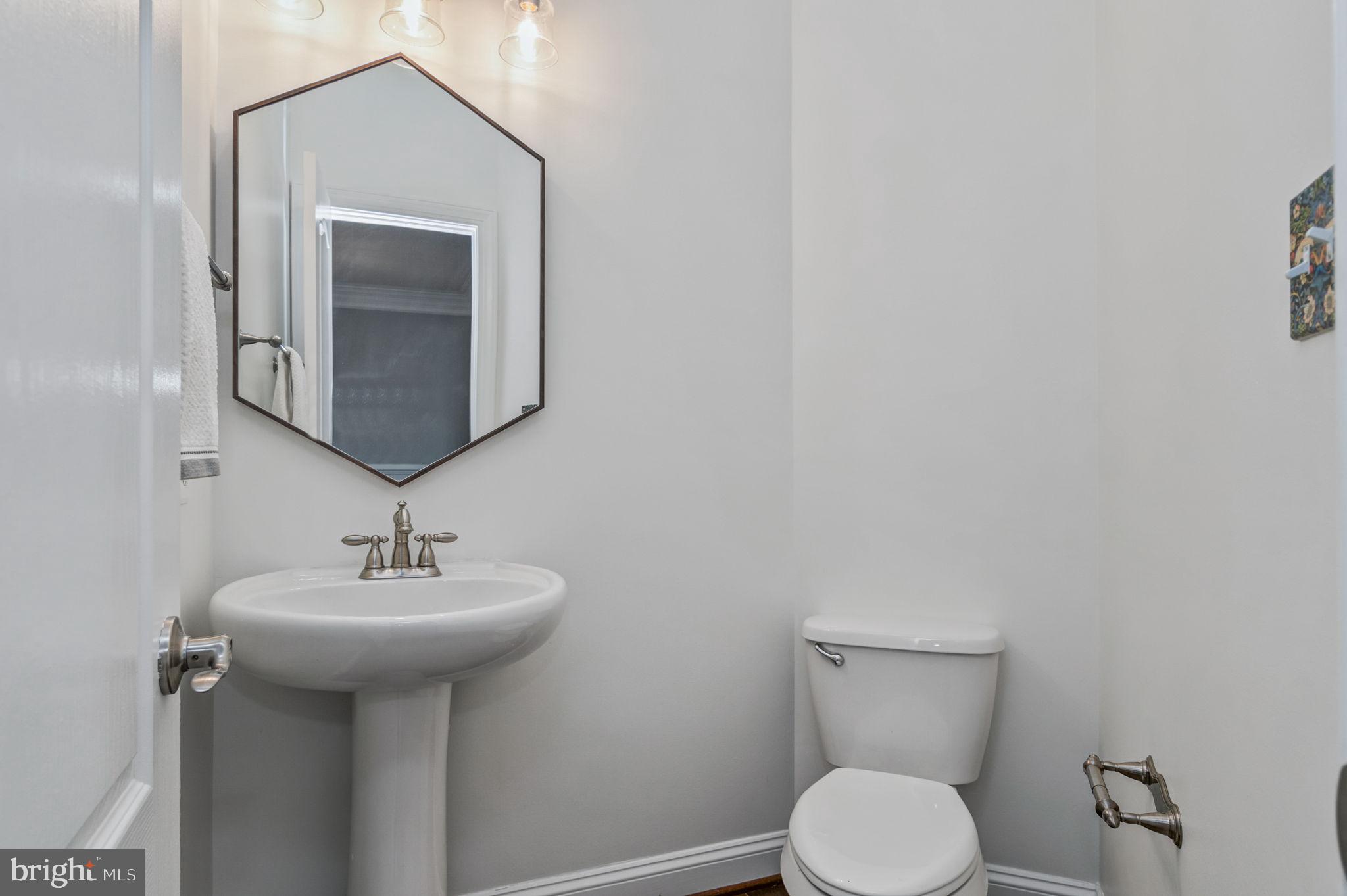5893 Riverside Drive Woodbridge, VA 22193 - Photo 7 of 36 a bathroom with a toilet sink and mirror