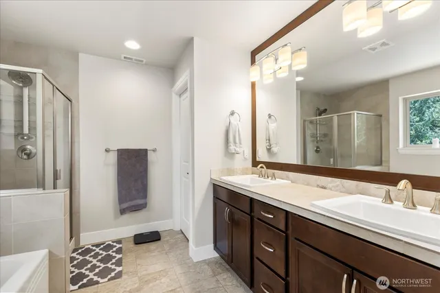 a bathroom with a double vanity sink and a mirror