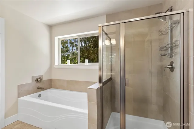 a bathroom with a tub and shower