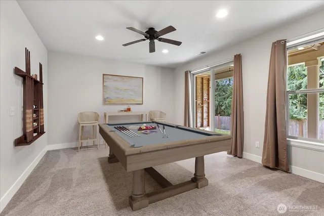 a view of a livingroom with a ceiling fan and window