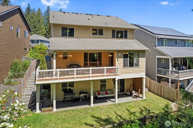 a balcony with wooden floor table and chairs