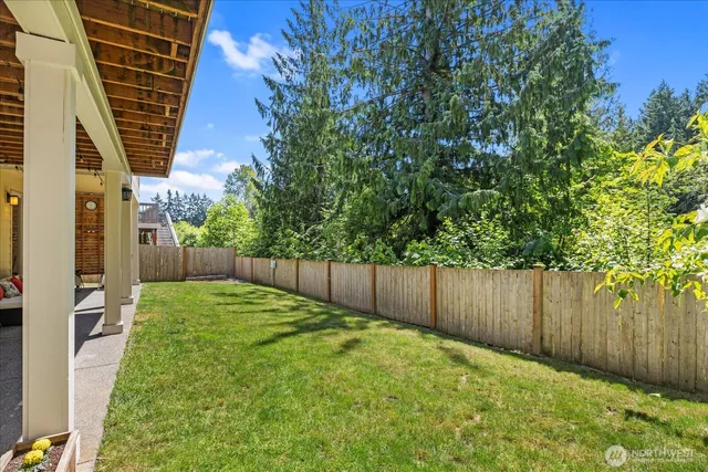 a view of a house with backyard porch and sitting area