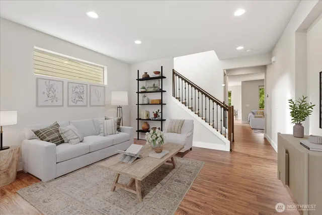 a living room with furniture and wooden floor