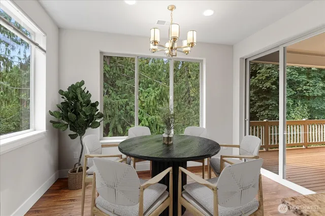a view of a dining room with furniture window and wooden floor