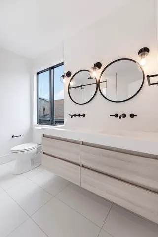 a bathroom with a sink a toilet and a mirror