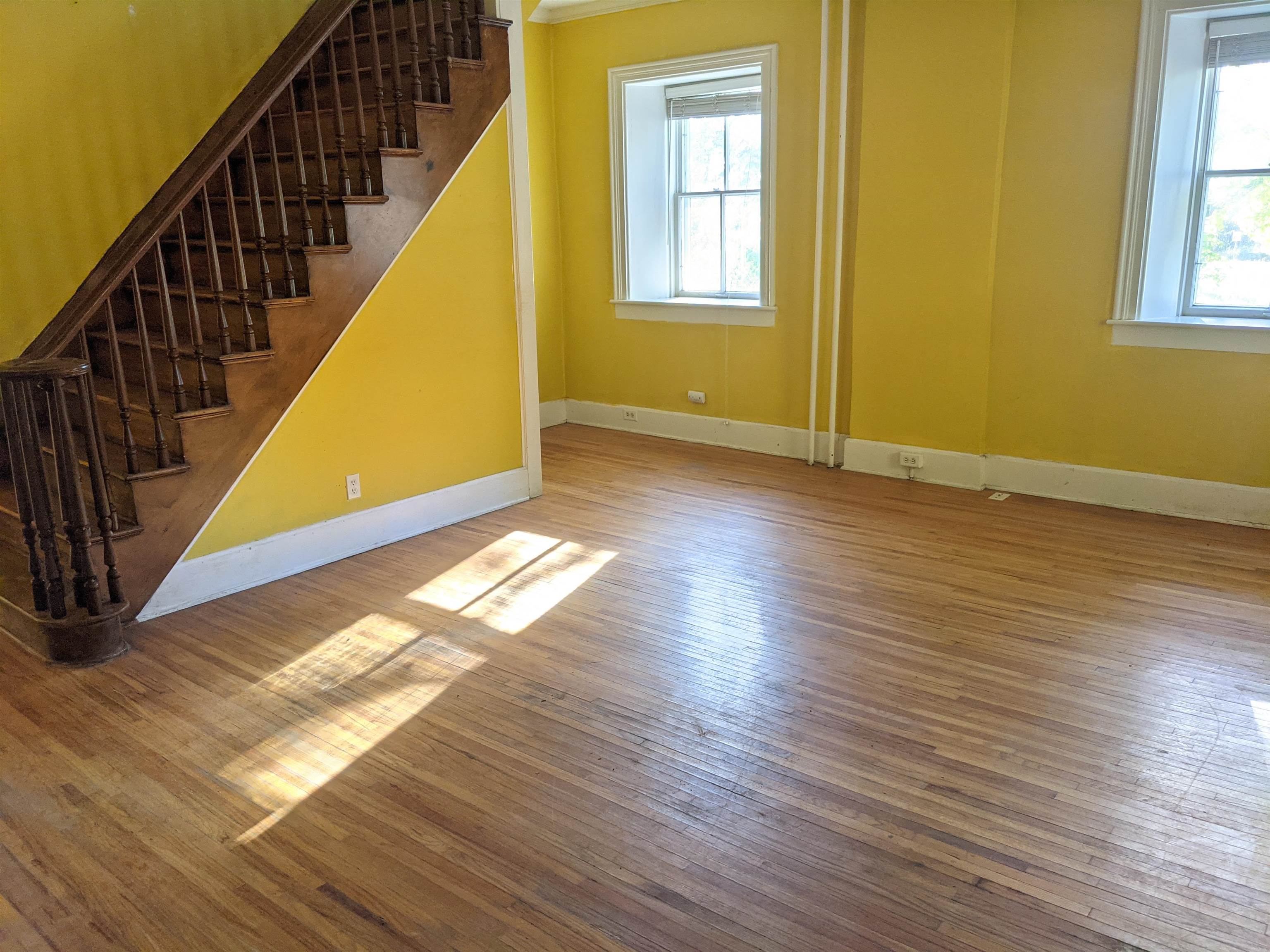 2243 East River Road Freeport, IL 61032 - Photo 3 of 33 a view of an empty room with wooden floor and windows