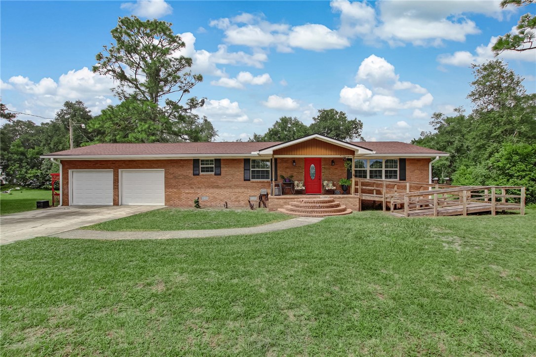 85091 Radio Avenue Yulee, FL 32097 - Photo 1 of 35 a front view of a house with garden