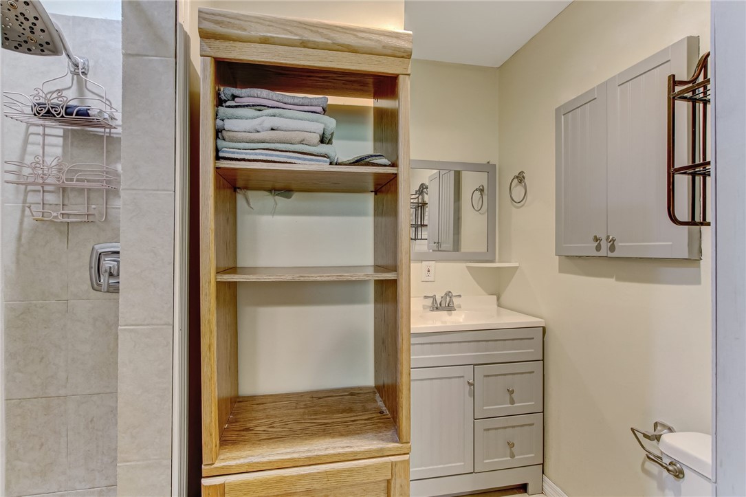85091 Radio Avenue Yulee, FL 32097 - Photo 16 of 35 a bathroom with a shower sink and mirror