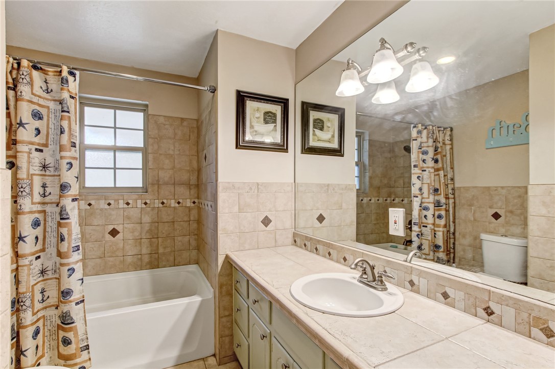 85091 Radio Avenue Yulee, FL 32097 - Photo 19 of 35 a bathroom with a tub sink and mirror