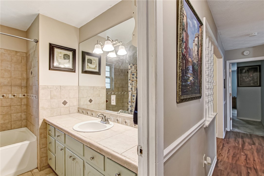 85091 Radio Avenue Yulee, FL 32097 - Photo 20 of 35 a bathroom with a granite countertop sink mirror and a shower