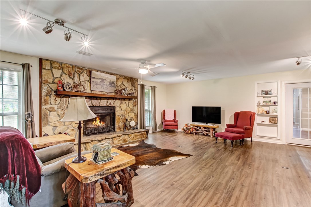 85091 Radio Avenue Yulee, FL 32097 - Photo 24 of 35 a living room with furniture a fireplace and wooden floor