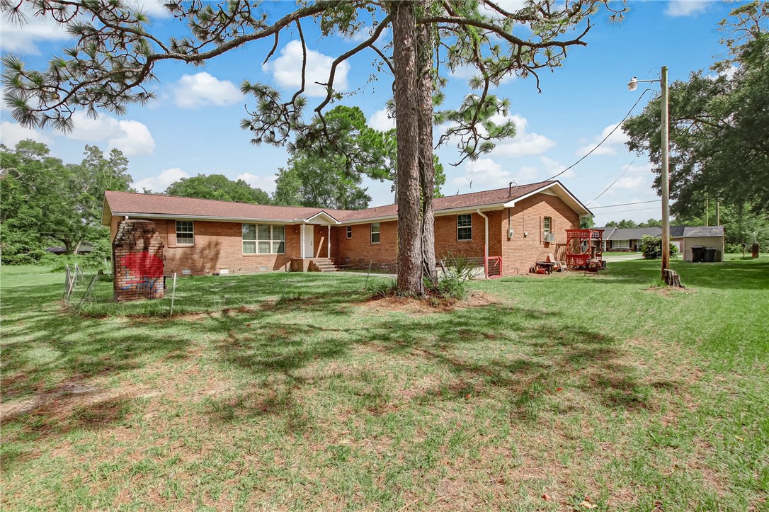 85091 Radio Avenue Yulee, FL 32097 - Photo 33 of 35 a front view of a house with garden