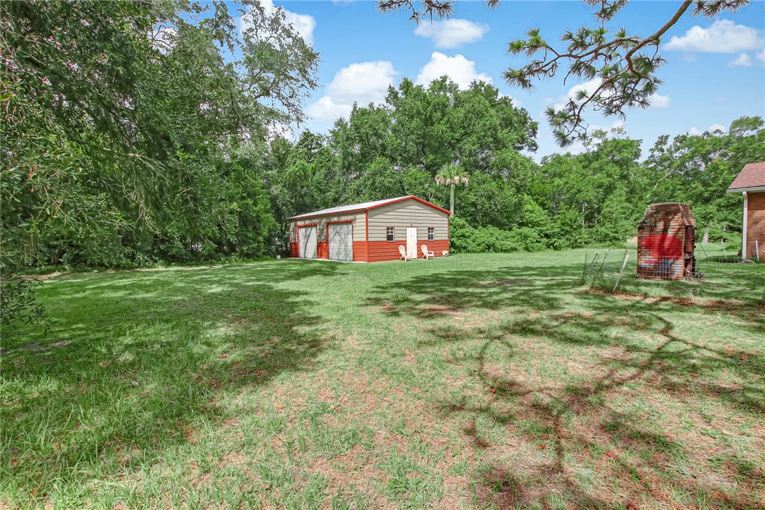 85091 Radio Avenue Yulee, FL 32097 - Photo 34 of 35 a view of a house with a yard