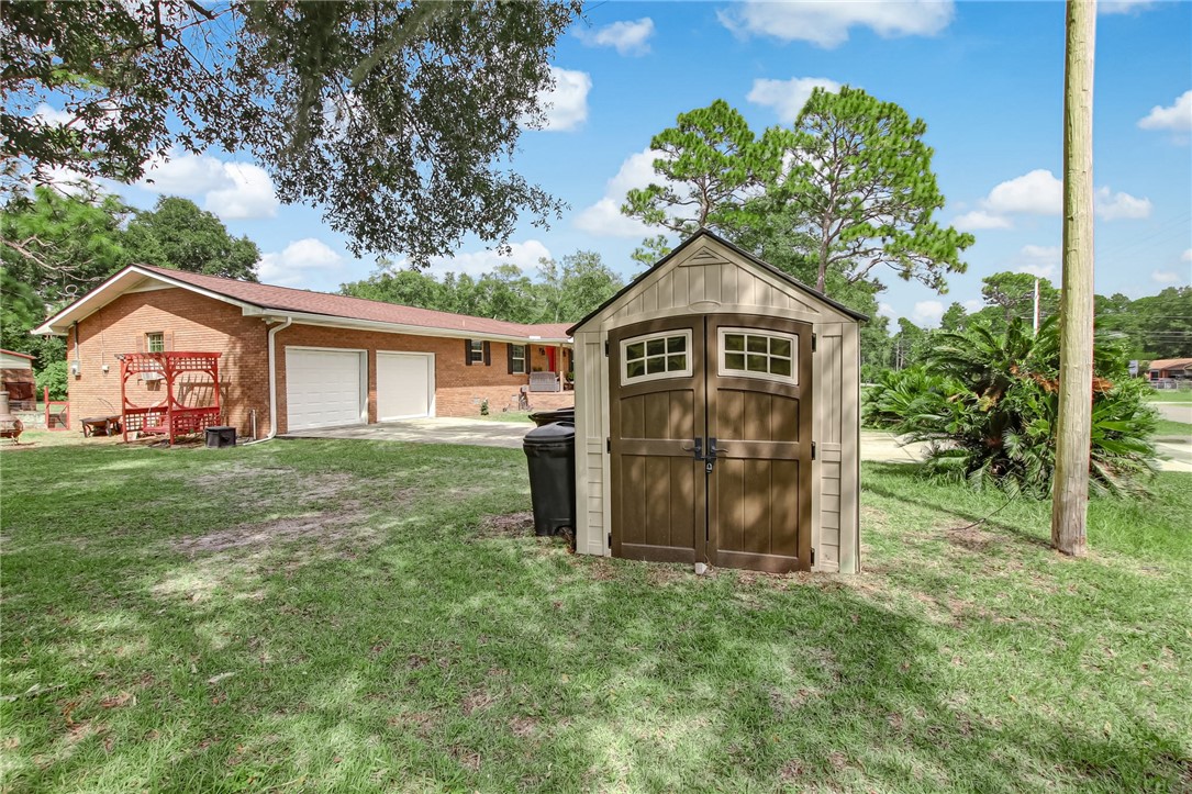 85091 Radio Avenue Yulee, FL 32097 - Photo 35 of 35 a view of a yard in front of a house with plants and large tree