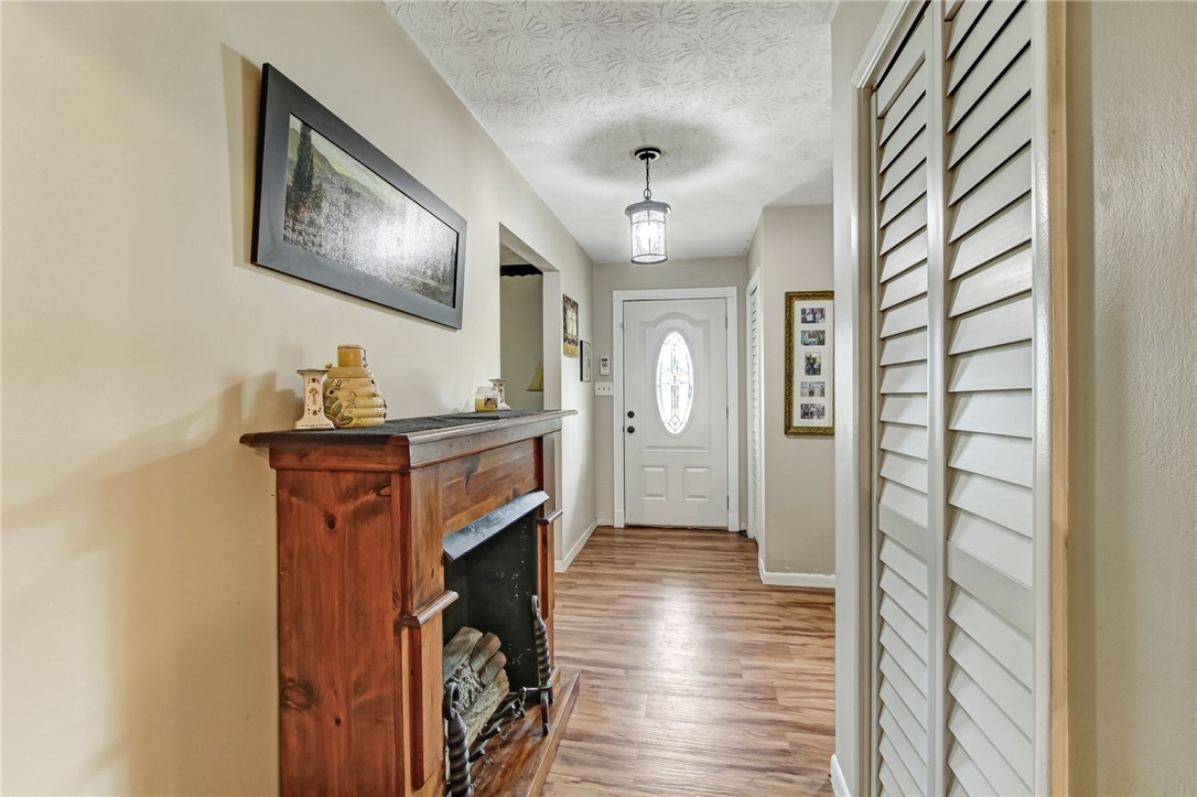 85091 Radio Avenue Yulee, FL 32097 - Photo 5 of 35 a view of a hallway with wooden floor and staircase