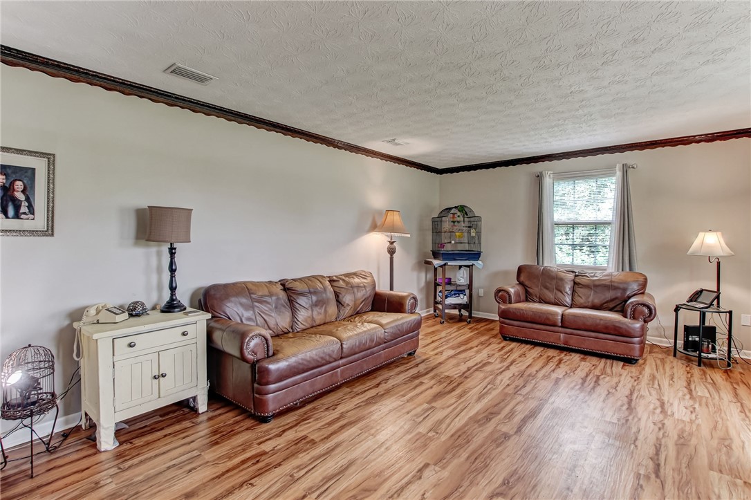 85091 Radio Avenue Yulee, FL 32097 - Photo 6 of 35 a living room with furniture and a wooden floor
