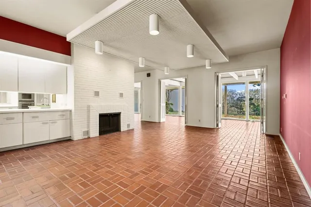 a view of a hallway with furniture and a fireplace