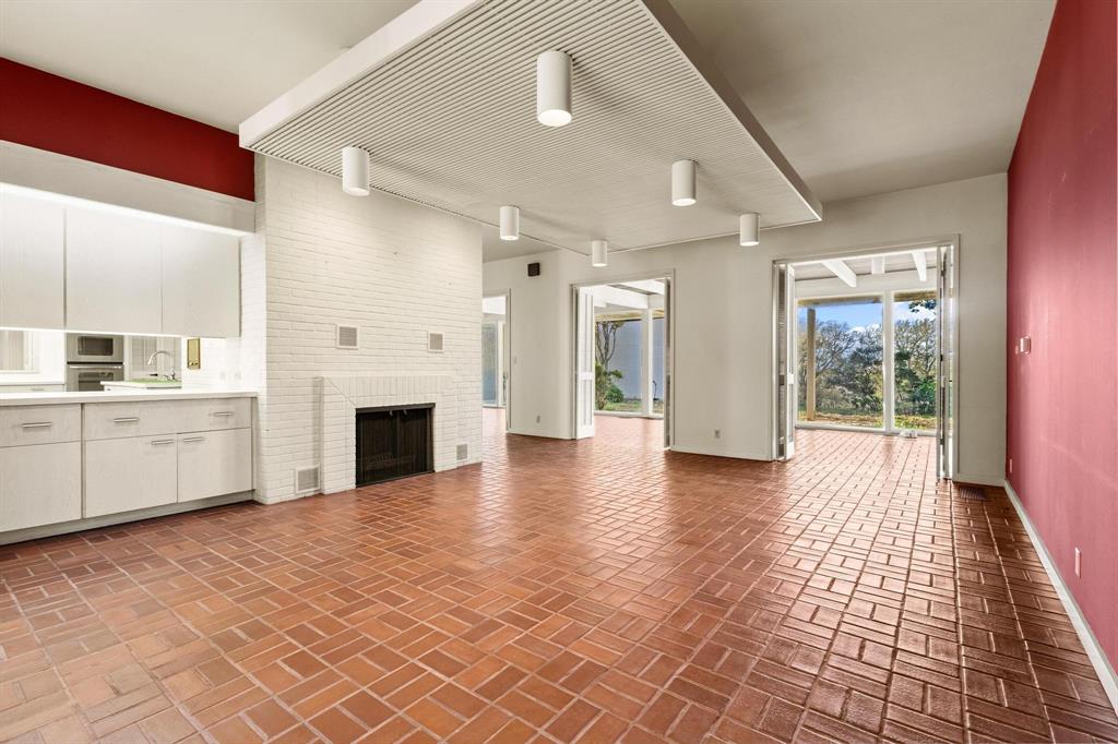 3906 Highland Drive Denison, TX 75020 - Photo 14 of 40 a view of a hallway with furniture and a fireplace