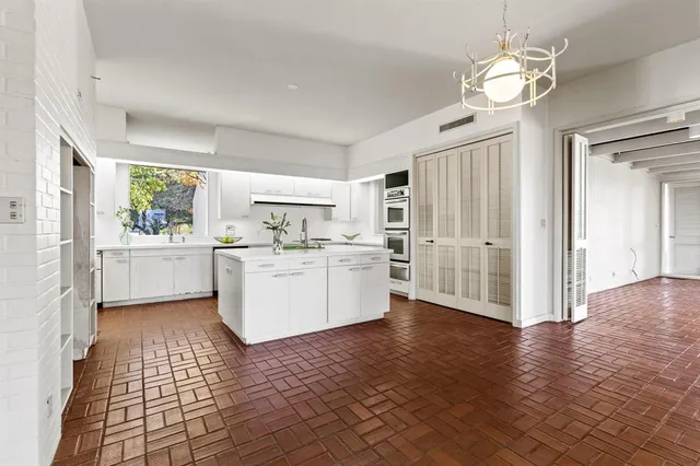 a view of a kitchen with wooden floor and a refrigerator