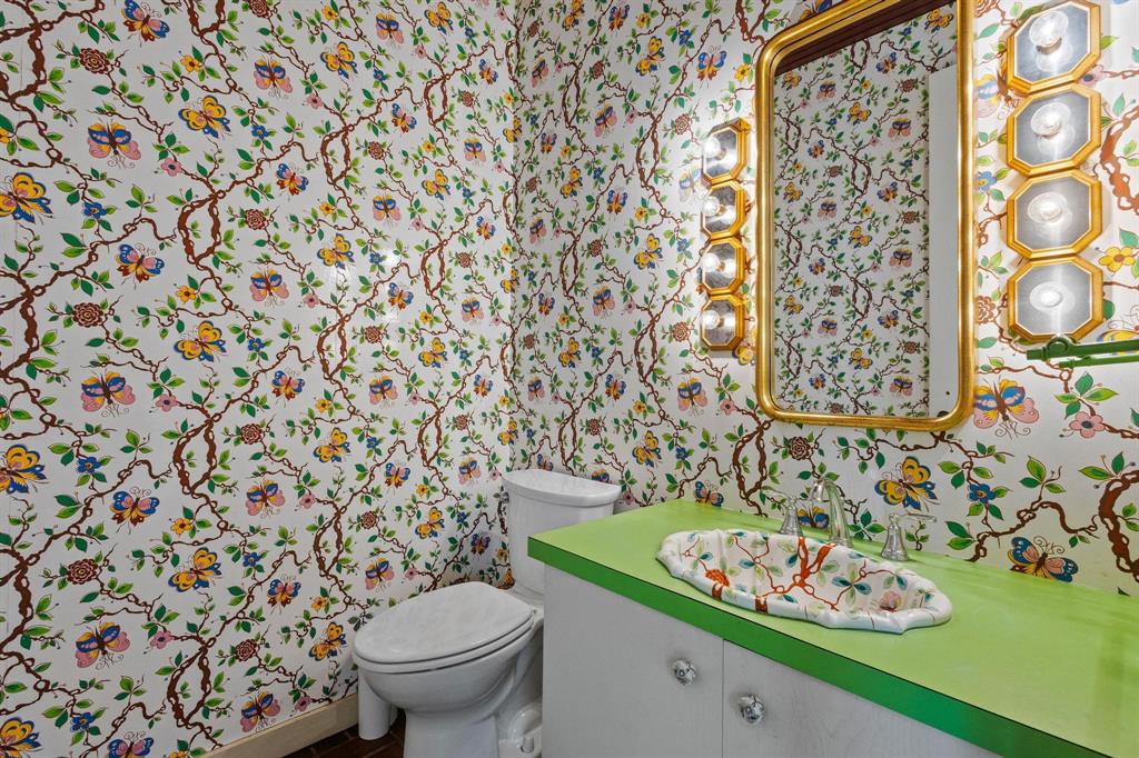 3906 Highland Drive Denison, TX 75020 - Photo 25 of 40 a bathroom with a toilet and a shower curtain