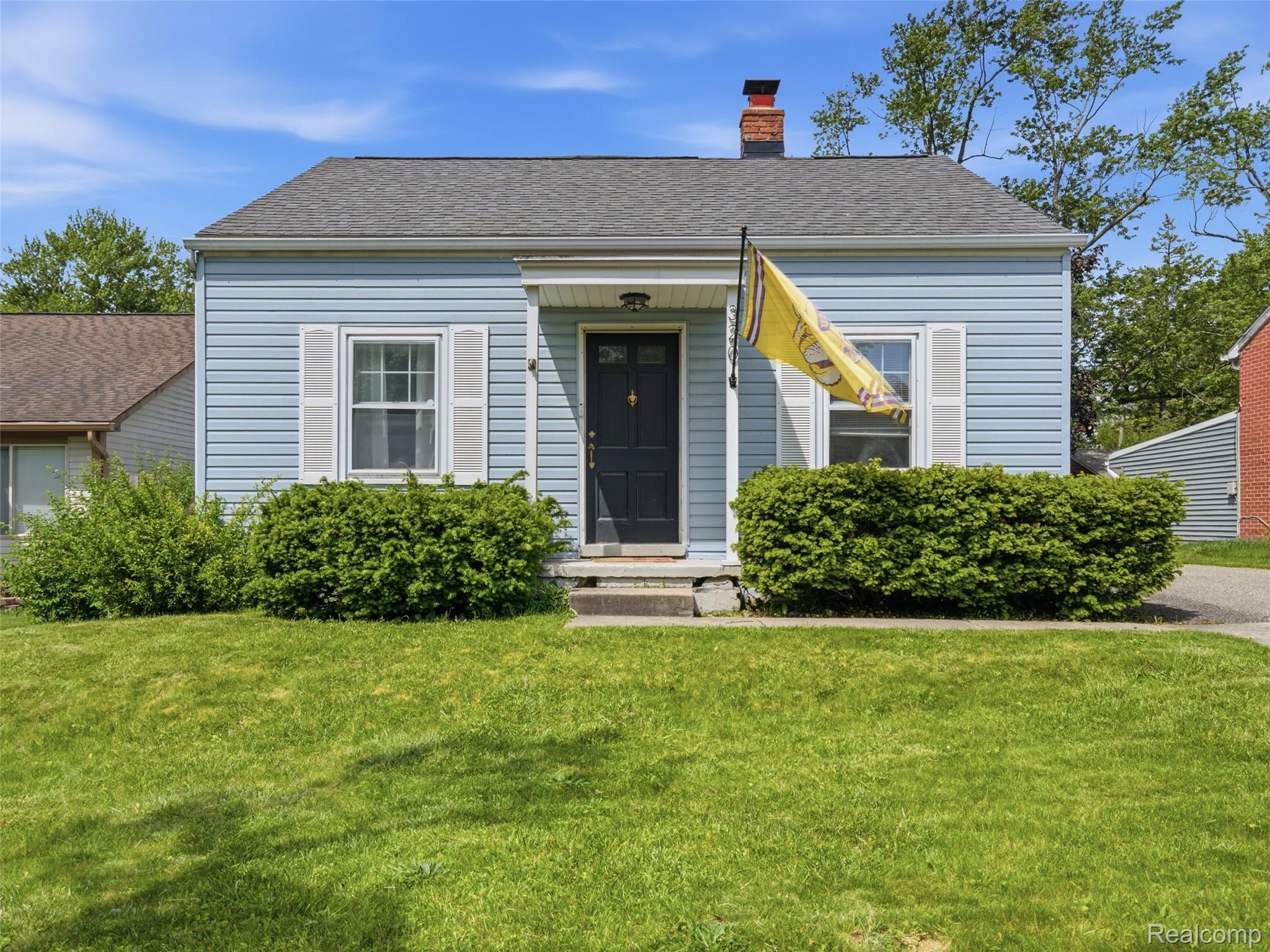 320 South Avery Road Waterford, MI 48328 - Photo 1 of 25 Light blue siding exterior with a dark gray shingled roof