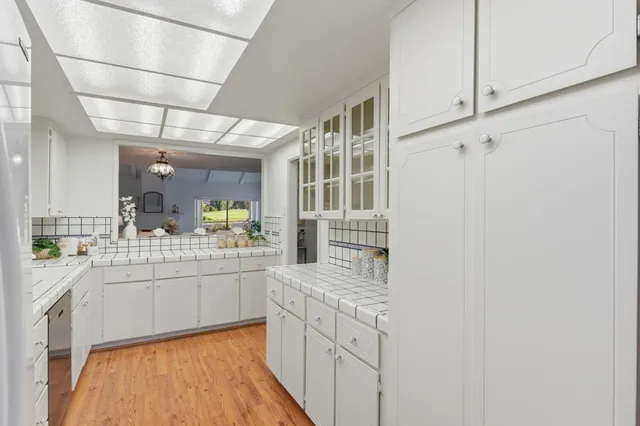a kitchen with stainless steel appliances granite countertop a sink and cabinets