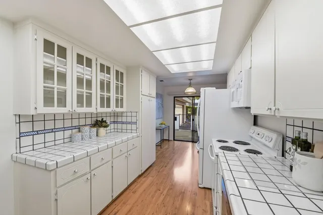 a kitchen with granite countertop a stove and a sink
