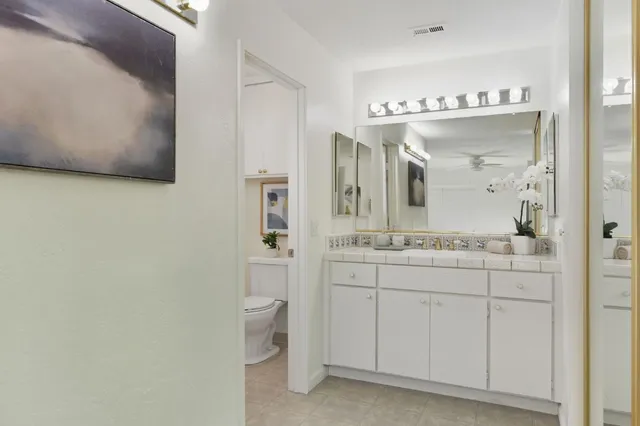 a bathroom with a sink a toilet and mirror