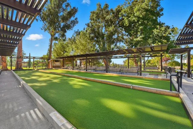 a swimming pool with outdoor seating and yard
