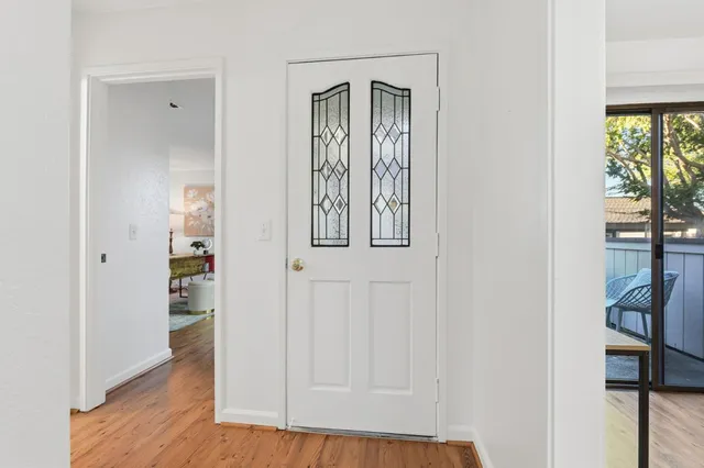a view of an entryway with wooden floor